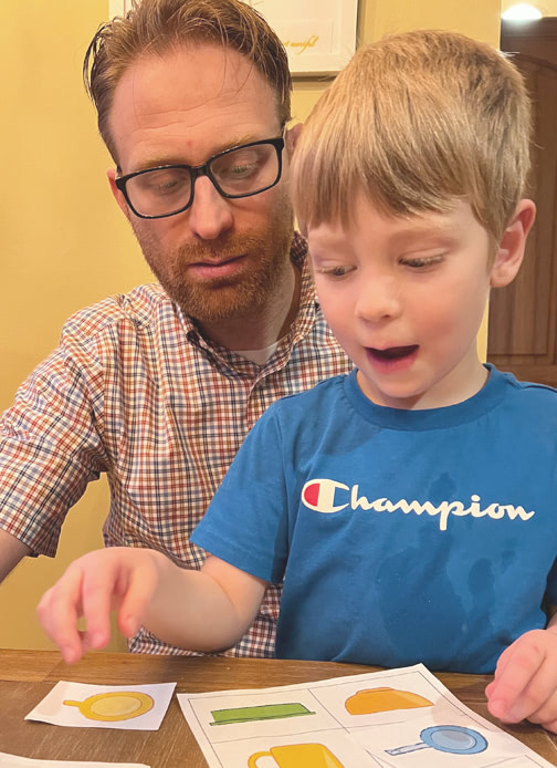 A father and son look at drawings of objects from an aerial perspective or bird’s eye view.