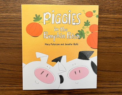The book “Piggies in the Pumpkin Patch” by Mary Peterson and Jennifer Rofé.