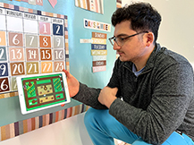 A man models playing goat challenge game in the Gracie & Friends “Map Adventures” preschool spatial thinking app.
