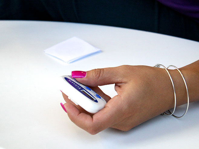Close-up of a teacher holding a timer.