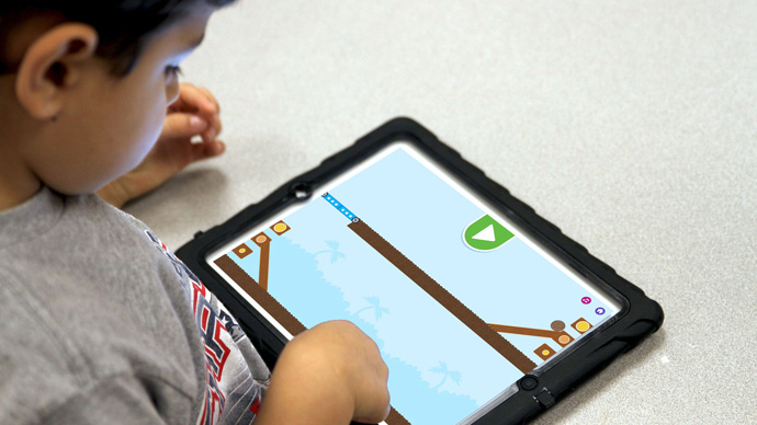 A preschool boy playing Coconut Star.