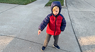 Child pointing to a driveway ramp.