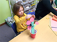 Student shows off their model of a tomato plant.