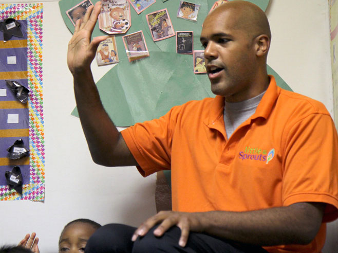 Teacher holds up five fingers.