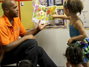 Teacher reading a book aloud to students.