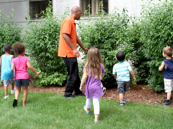 Students look for scavenger hunt items in nature.
