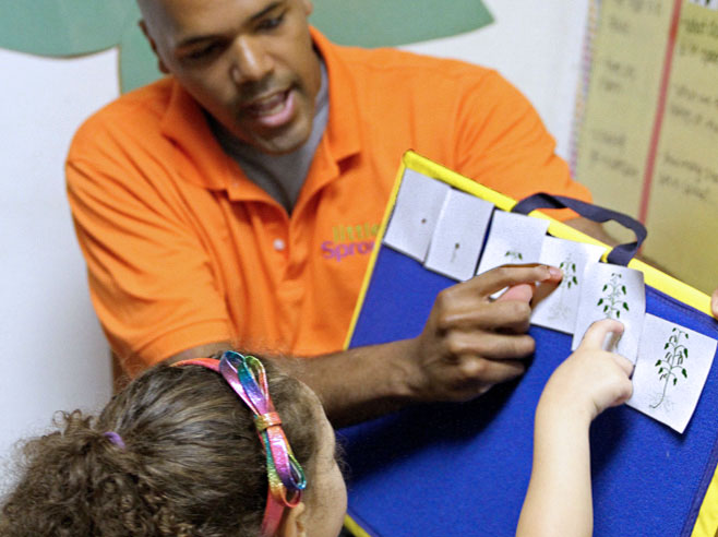 Teacher and student point to the cards.
