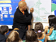 Teacher draws on the large class diagram of a plant.