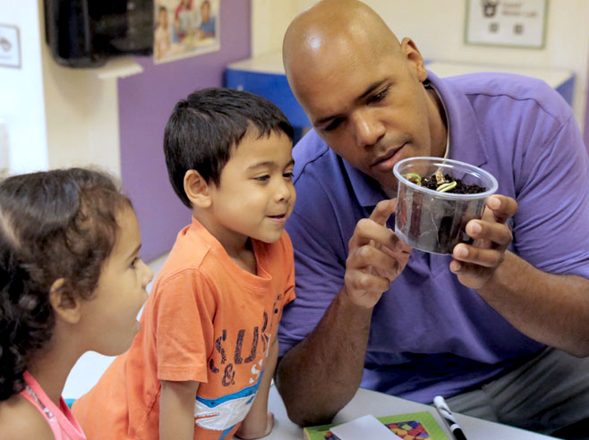 Two students describe their observations to the teacher.