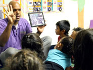 Teacher shows a video to students.