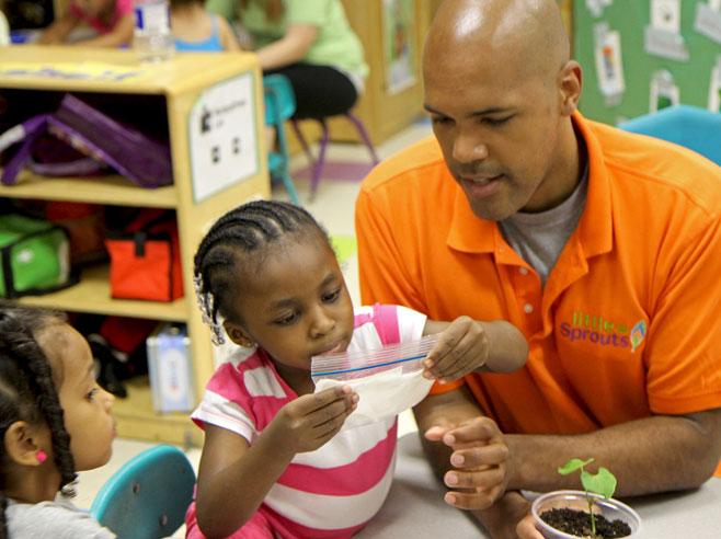 Student closing a baggie with teacher's help.