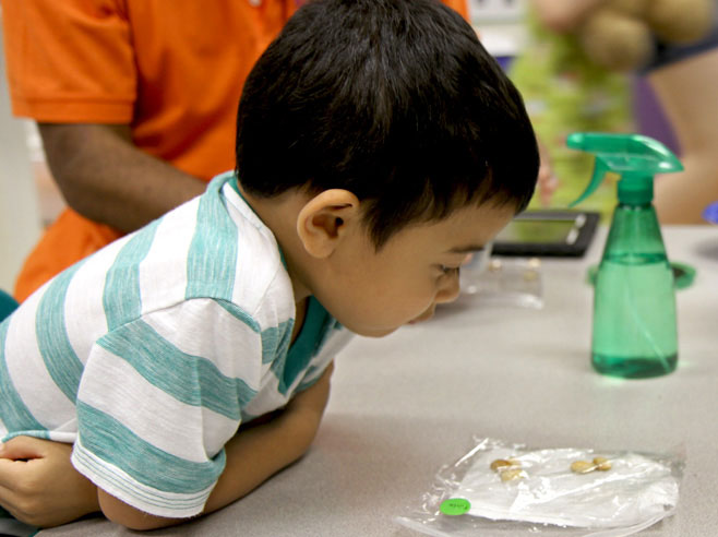Student looking at bag of seeds.