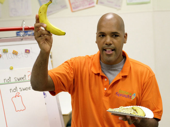 Teacher holds up a banana.