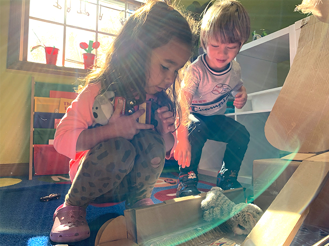 Two students gather items for the obstacle course.