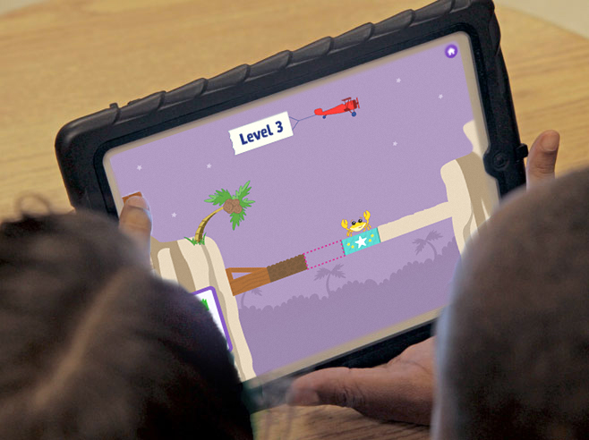 Students playing Coconut Canyon app on iPad.