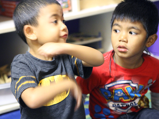 Student motions with arms how a ball will roll.